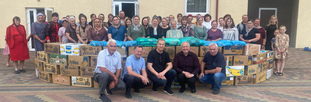 Peter and Yuriy in front of a group of widows in Ukraine